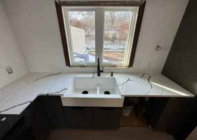 apron front sink black faucet white stone withrow mn