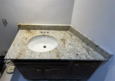 bathroom vanity with white sink and stone countertop oak park heights mn