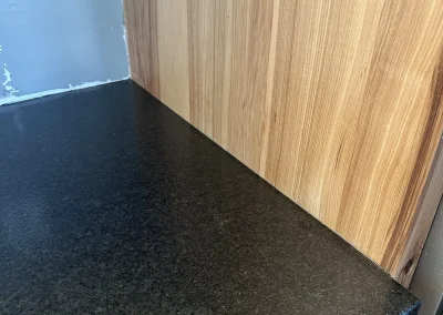 black stone countertop flush against wood cabinet birchwood village mn