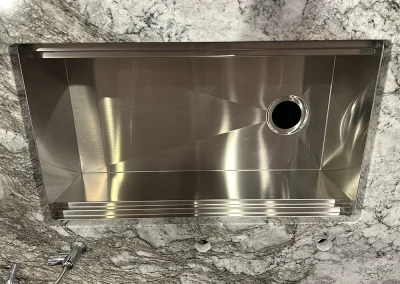 undermount sink with accessories ledge in stone counter baxter