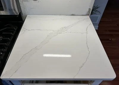 white quartz style countertop next to stove trimbelle wi